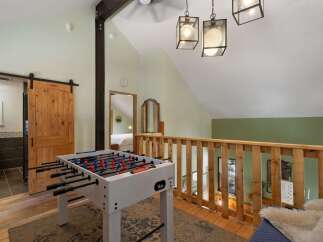 Enjoy endless fun with this charming loft featuring a foosball table, perfect for game nights.