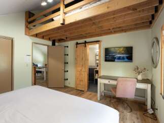 Discover this charming bedroom featuring a unique lofted sleeping area, perfect for maximizing space and adding a touch of adventure.