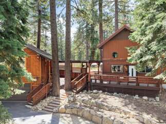 Nestled amongst towering pine trees, this charming cabin offers a serene mountain retreat.