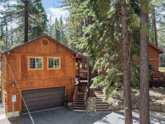 Nestled among tall pine trees, this charming wooden home offers a serene mountain retreat.