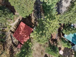 Discover this charming property nestled amongst mature pine trees, offering a serene and private retreat.