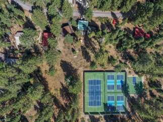 Discover this unique property featuring multiple recreational amenities, including a basketball court and four pickleball courts, perfect for active living.