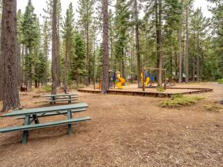 Enjoy outdoor fun at this property featuring a dedicated playground area with slides and swings, perfect for children's entertainment.
