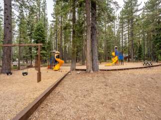 Enjoy outdoor fun at this property's fantastic playground, complete with swings and vibrant yellow slides.