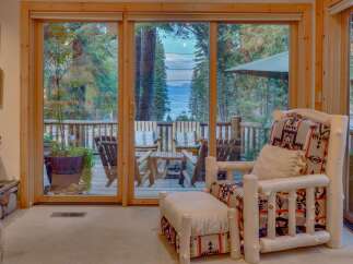 Experience breathtaking lake and mountain views from this charming cabin, featuring a spacious deck perfect for outdoor entertaining.