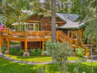 Experience rustic charm in this beautiful log cabin, nestled amongst lush trees.