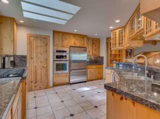 Discover this stunning kitchen featuring custom knotty pine cabinetry and granite countertops.