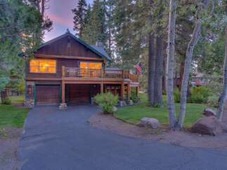 Experience rustic charm in this beautiful log cabin home, nestled amongst towering pine trees.