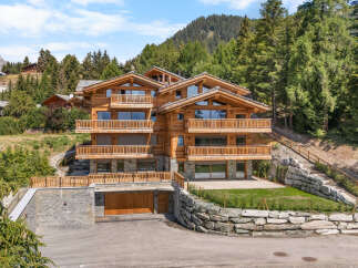 Experience luxury mountain living in this stunning wooden chalet, nestled amidst a serene forest landscape.