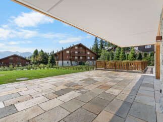 Experience outdoor living at its finest on this expansive stone patio, perfect for entertaining or simply enjoying the serene mountain views.