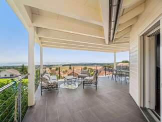 Enjoy breathtaking panoramic views from this stunning covered patio, perfect for al fresco dining or relaxing with a book.