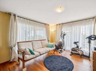 This bright and airy room features a comfortable sofa, perfect for relaxing after a workout.