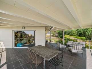 Enjoy outdoor living on this spacious covered patio, perfect for al fresco dining or relaxing with a view.