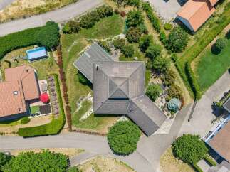 Discover this stunning aerial view showcasing a modern home with a distinctive multi-level roof design.