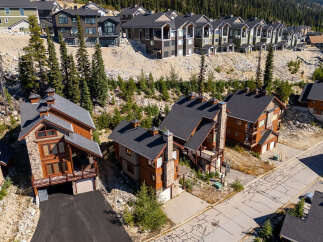 Discover luxury mountain living in this stunning multi-unit property, featuring modern architecture with natural stone and wood accents.