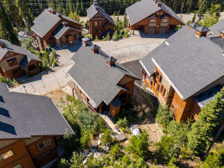 Discover luxury mountain living in this stunning timber-frame home, nestled amidst towering evergreens.
