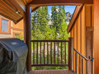 Enjoy outdoor living on this charming balcony, complete with a covered Weber grill perfect for summer cookouts.