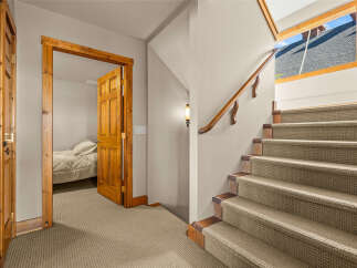Discover comfort and style in this inviting home featuring a charming wooden door leading to a cozy bedroom.