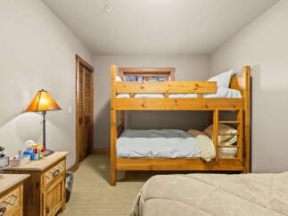 This charming bedroom features a sturdy wooden bunk bed, perfect for accommodating guests or children.