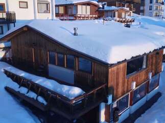 Experience the ultimate winter getaway in this charming wooden chalet, nestled amidst a snowy landscape.