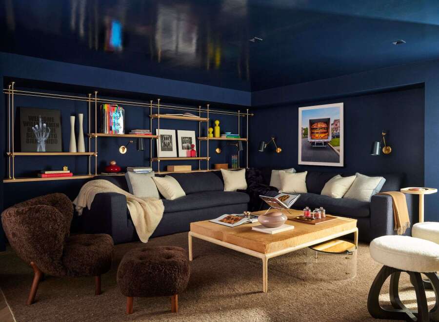 Step into a sophisticated living space featuring a deep navy blue palette that creates a dramatic and luxurious atmosphere.