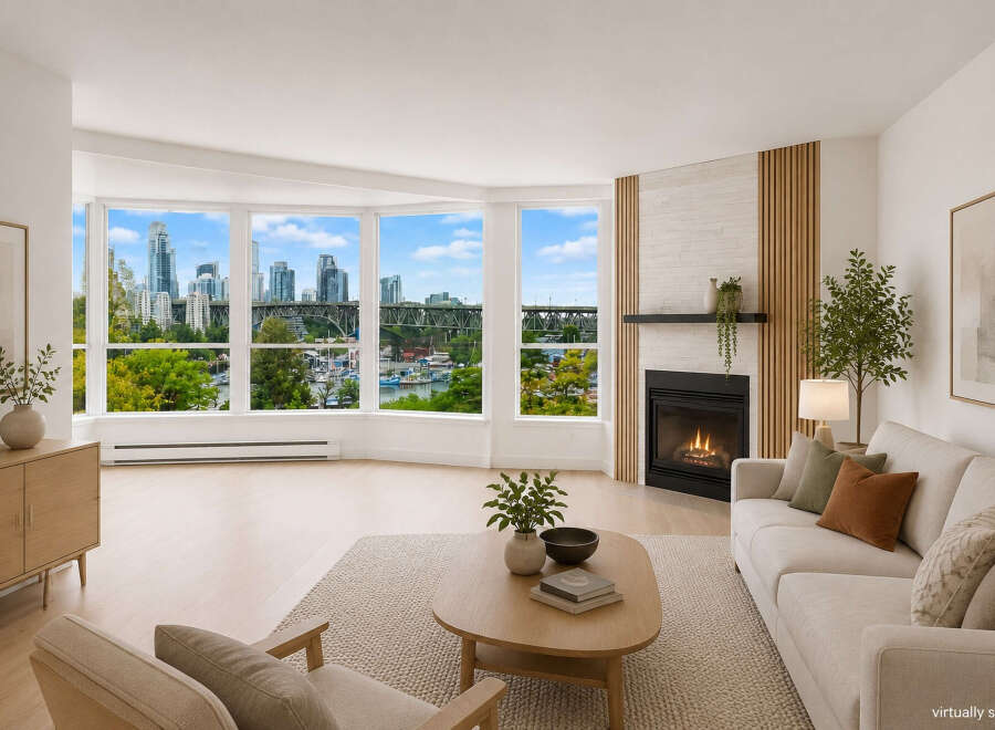 Experience breathtaking city and water views from this stunning living room, featuring a modern gas fireplace and elegant wood-slat accent wall.