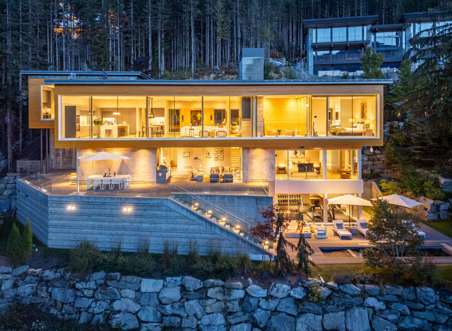 Experience luxury living in this modern architectural masterpiece nestled in a serene forest setting.