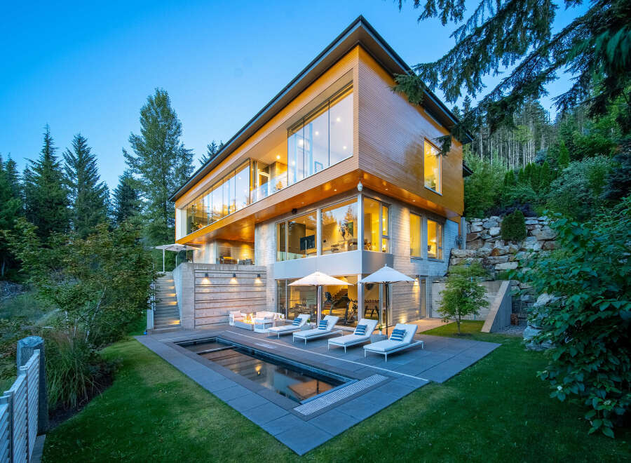 Experience luxury living in this modern architectural masterpiece nestled amidst a serene forest landscape.