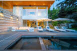 Experience luxury outdoor living with this stunning patio featuring a modern fire pit and comfortable lounge seating.
