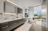 Experience luxury in this stunning master bathroom featuring a freestanding soaking tub with breathtaking mountain views.