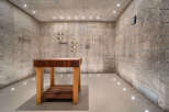 Discover a unique wine cellar featuring raw concrete walls and a minimalist aesthetic, perfect for the discerning collector.