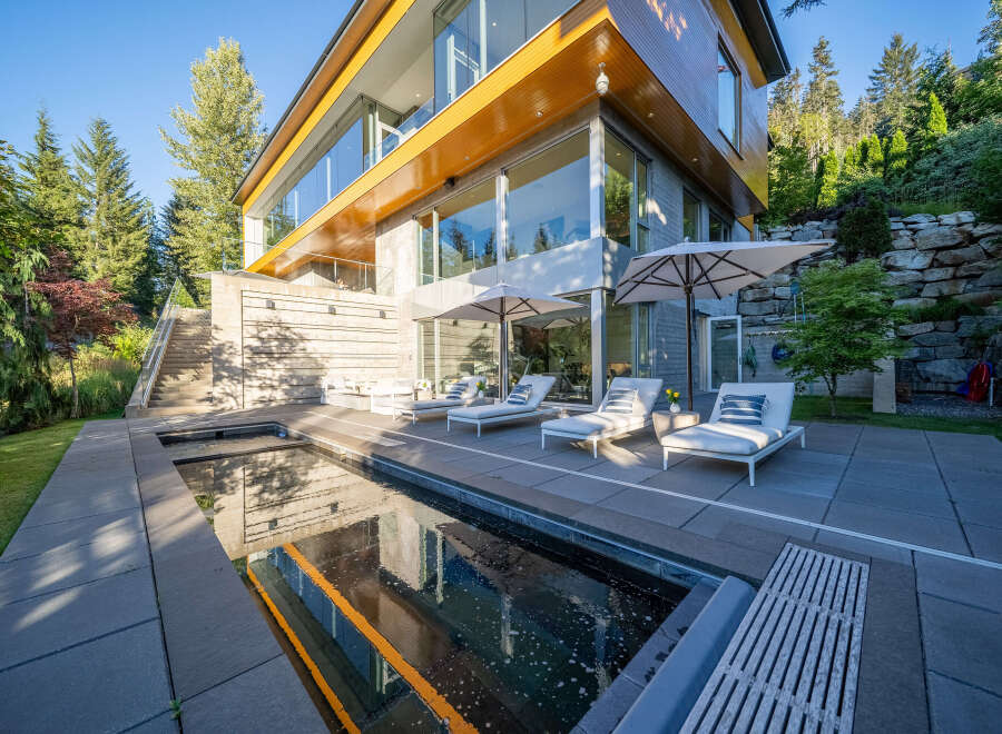 Experience luxury living in this modern architectural masterpiece, featuring expansive glass walls and natural wood accents.
