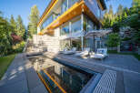 Experience luxury living in this modern architectural masterpiece, featuring expansive glass walls and natural wood accents.