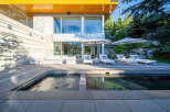 Experience luxury outdoor living with this stunning patio featuring a modern pool and spa.