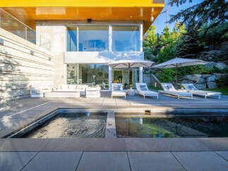 Experience luxury outdoor living with this stunning patio featuring a modern pool and spa.