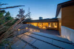 Experience modern luxury in this stunning home, featuring a sleek concrete and wood exterior.