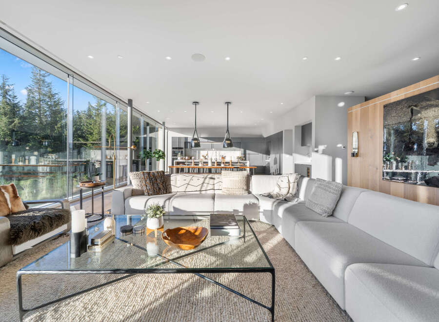 Experience modern luxury in this stunning living room, featuring a spacious sectional sofa perfect for relaxation and entertaining.