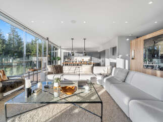 Experience modern luxury in this stunning living room, featuring a spacious sectional sofa perfect for relaxation and entertaining.