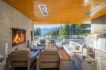 Experience luxurious outdoor living with this stunning patio featuring a cozy fireplace and a fully equipped grill station.