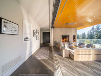 Experience seamless indoor-outdoor living with this stunning covered patio, featuring a modern concrete fireplace and comfortable lounge seating.