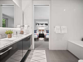 Experience modern luxury in this stunning bathroom featuring a sleek vanity with marble countertops and a deep soaking tub.