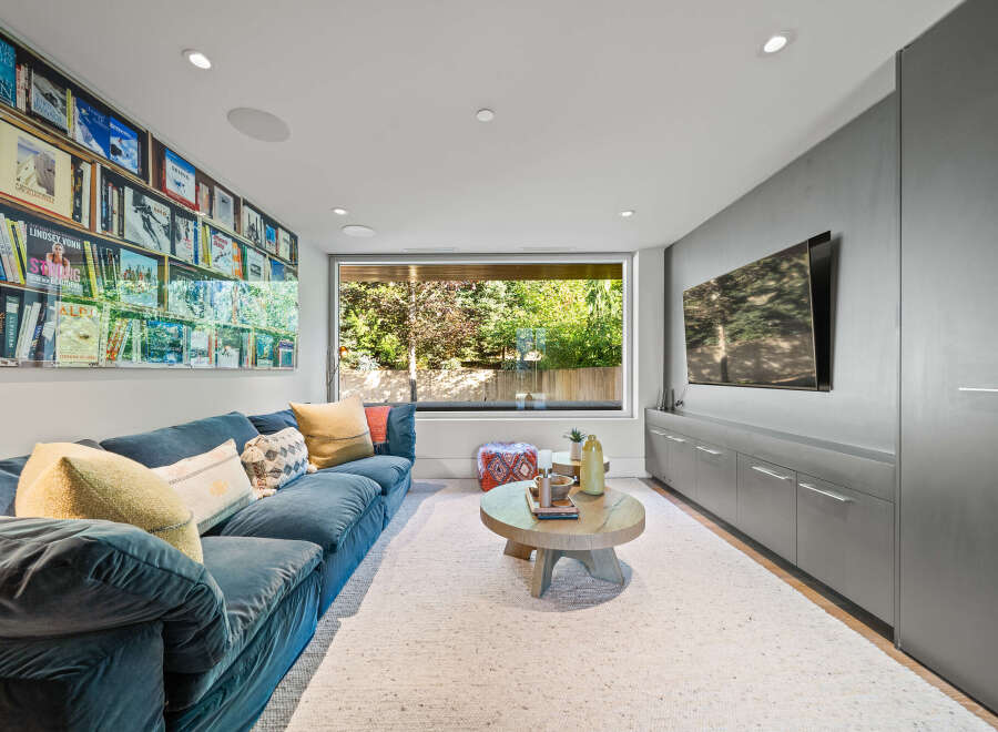 Experience ultimate relaxation in this modern living room, featuring a plush blue sectional sofa perfect for movie nights.