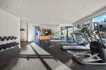 Elevate your fitness routine in this well-equipped home gym, featuring a full set of dumbbells, treadmills, and an elliptical machine.