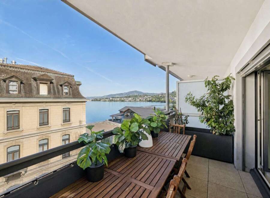 Enjoy breathtaking lake views from this stunning balcony, perfect for al fresco dining or relaxing with a morning coffee.