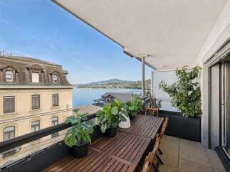 Enjoy breathtaking lake views from this stunning balcony, perfect for al fresco dining or relaxing with a morning coffee.