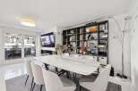 Experience modern living in this elegant dining area, featuring a stunning marble-top dining table surrounded by comfortable upholstered chairs.