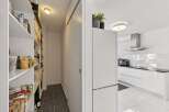 Discover a spacious pantry with ample shelving, perfect for organizing all your groceries and kitchen essentials.