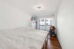This charming bedroom features a comfortable bed with a white duvet, perfect for relaxation.