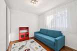 This inviting room features a comfortable blue sofa, perfect for relaxing or entertaining.