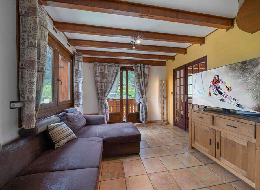 Experience cozy living in this charming room featuring a plush sectional sofa perfect for relaxation.